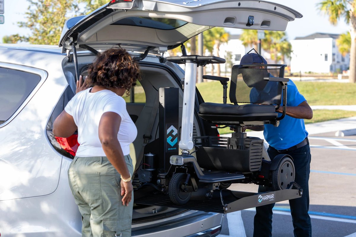AL600 raising a power chair into the cargo area of a white SUV