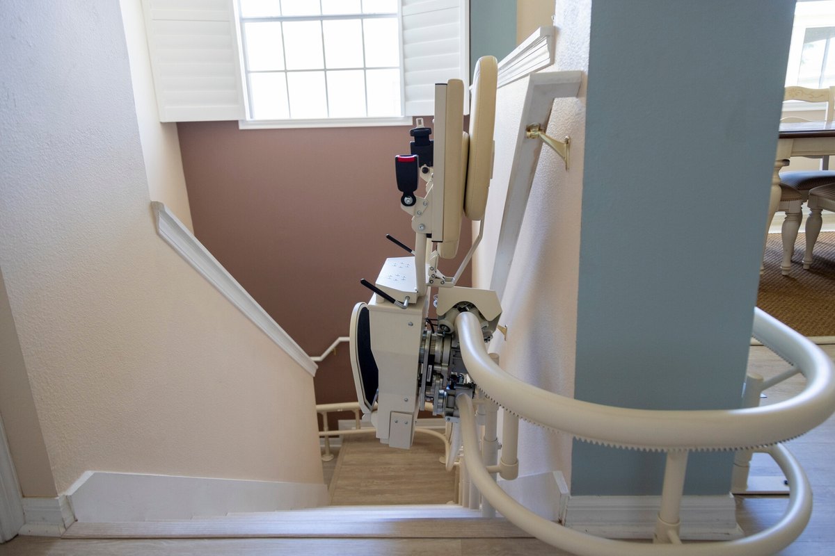 Helix seat climbing a rail that wraps around a column toward the upper floor