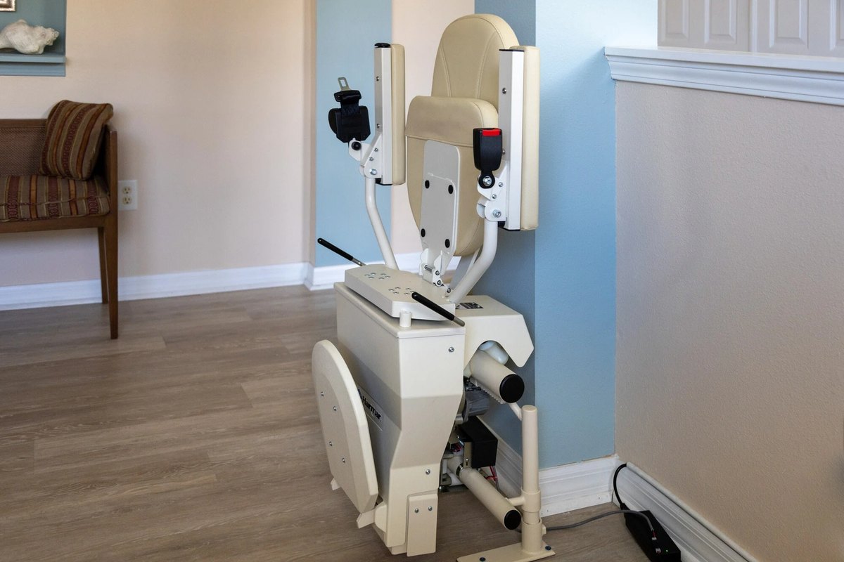 Helix lift with its seat folded, parked by a support column