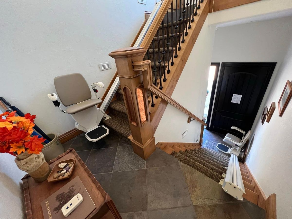 Lazo install: entry hall with a stair lift on the short flight and one on the basement stairs