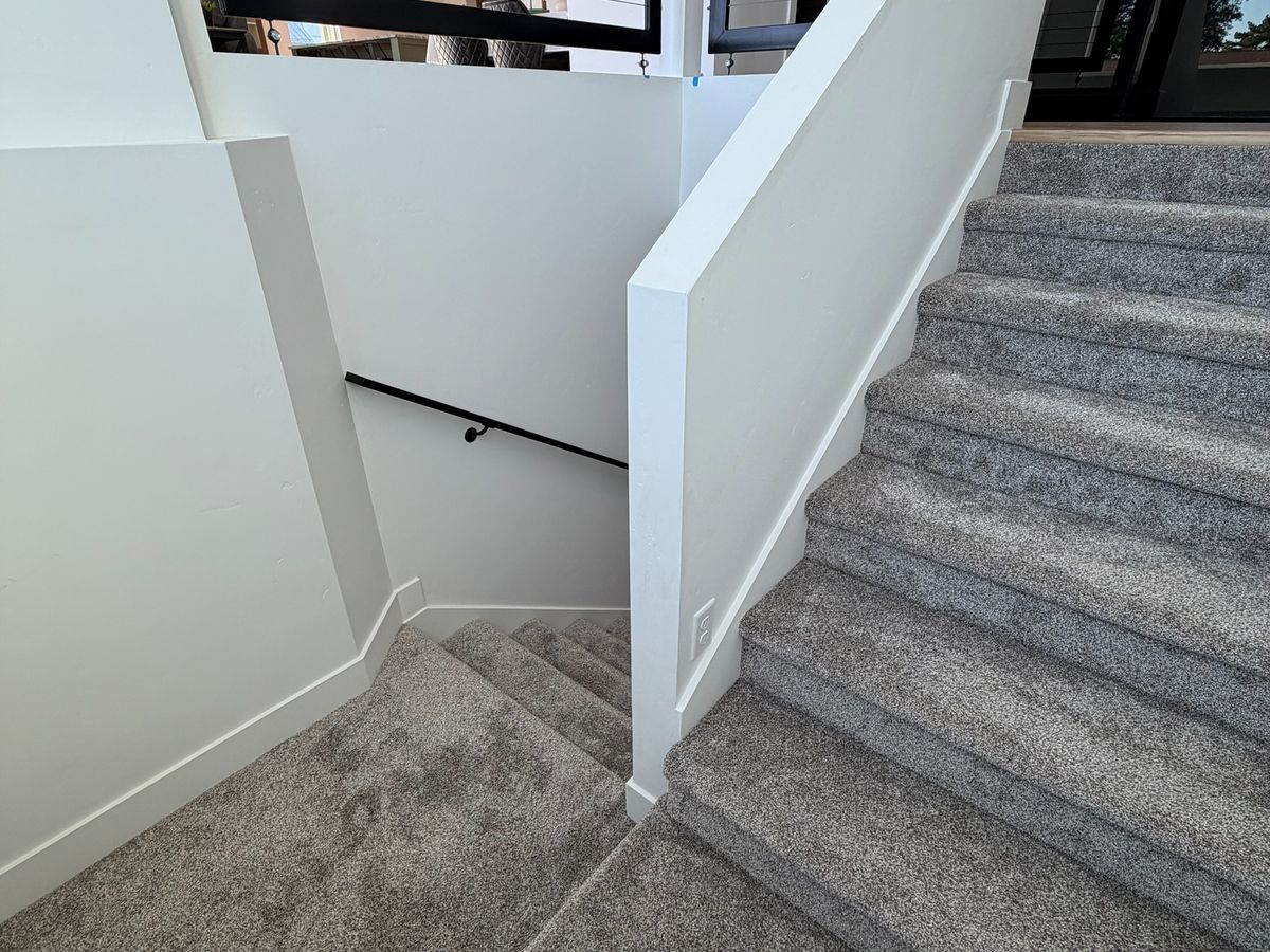 The same staircase from the lower landing, bare carpet, before the stair lifts