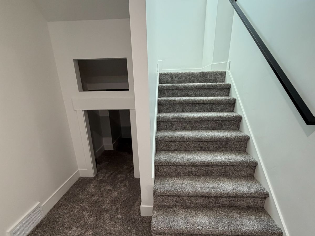 The same straight flight under a skylight, before the stair lift