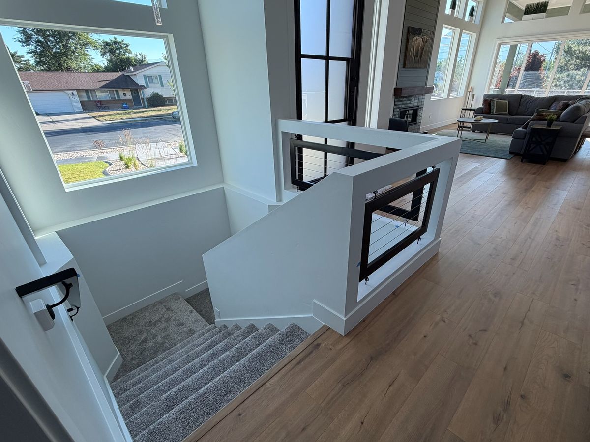 The same wood-floored landing at the top of the stairs, before the stair lift