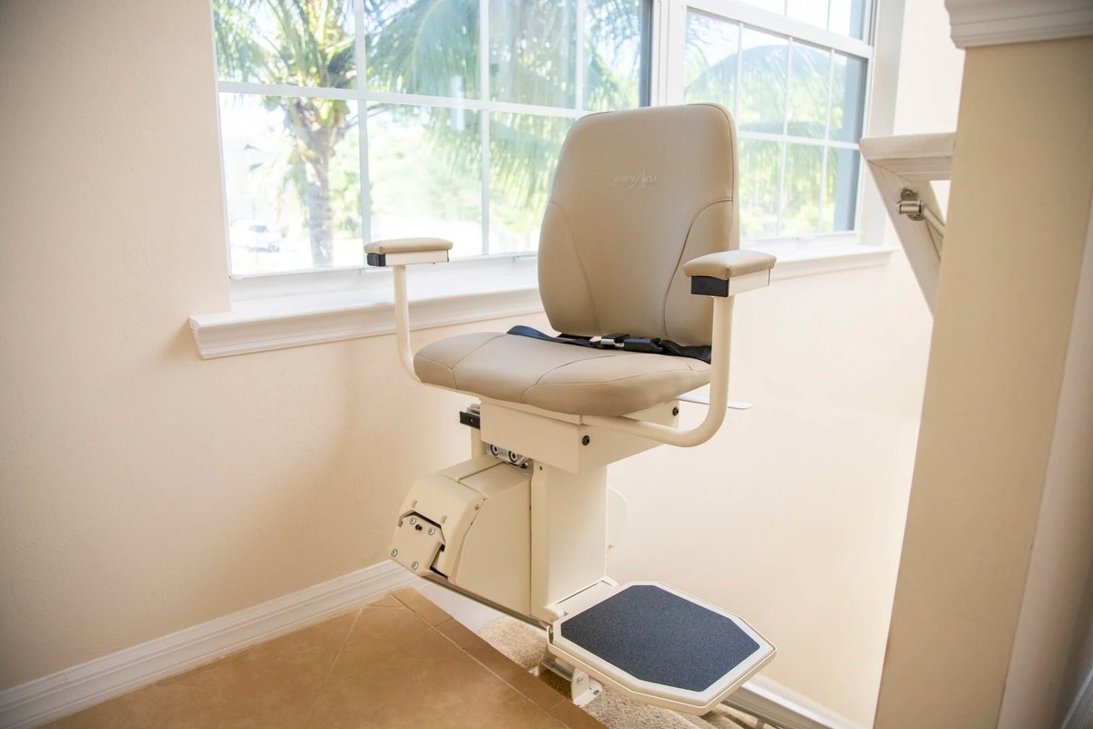 Harmar SL600HD heavy-duty stair lift with a high back and wide seat at the top of the stairs
