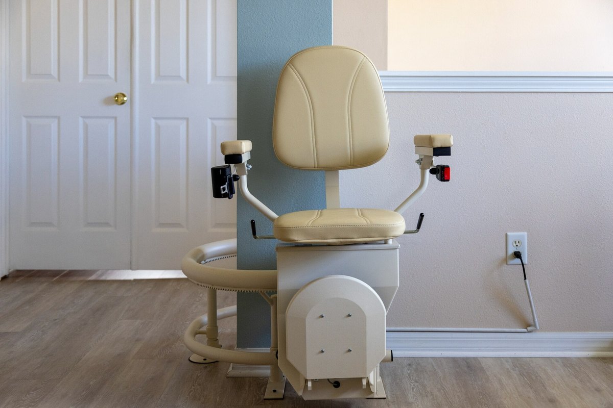 Harmar Helix curved stair lift with its seat down beside a blue column