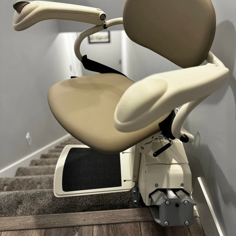 Harmar SL300 stair lift at the top of a carpeted staircase