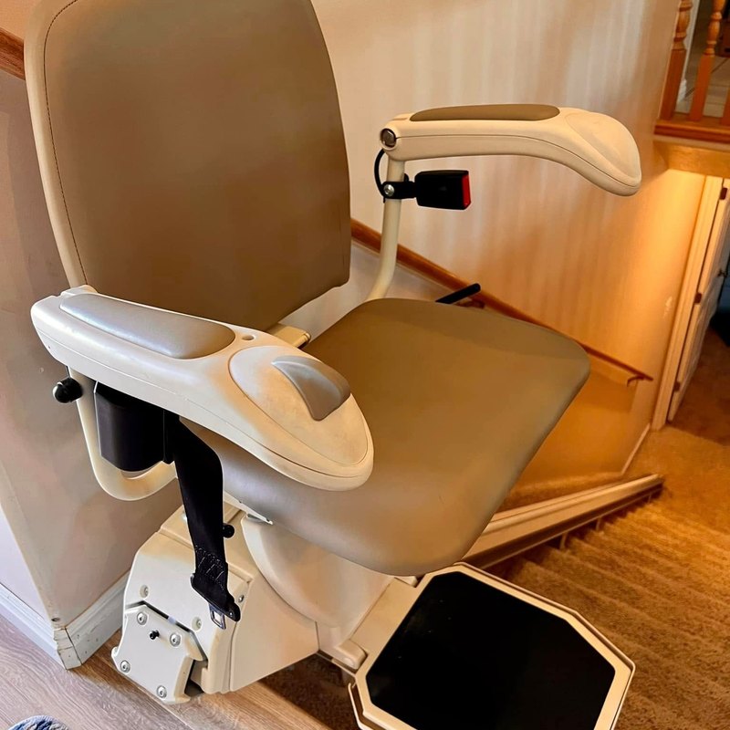 Harmar stair lift seat and footrest ready at the bottom of the stairs