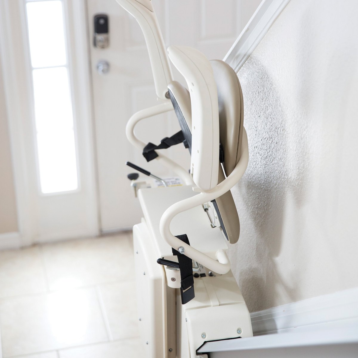Harmar SL300 stair lift folded up beside a front door