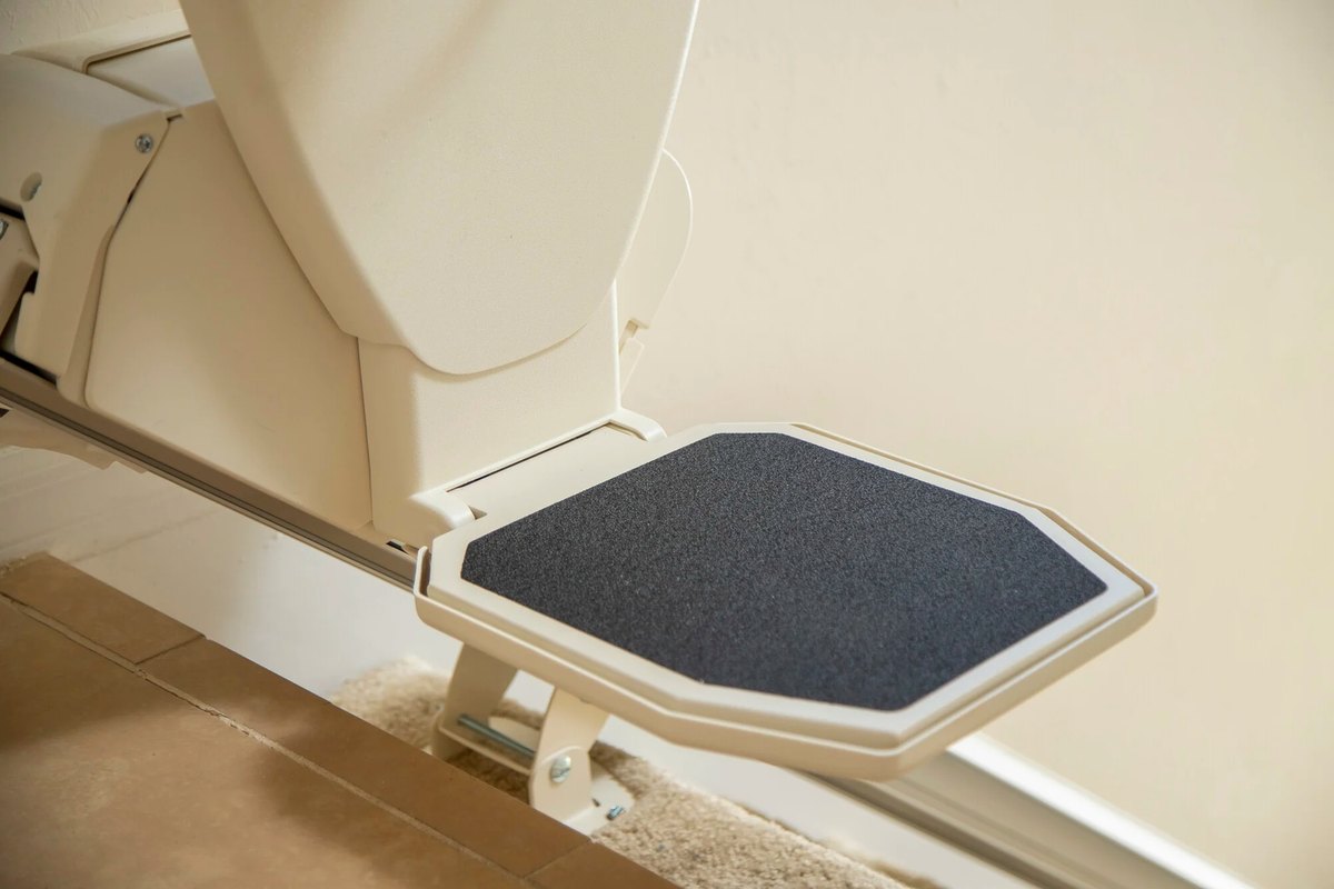 Footrest of a Harmar SL600 stair lift above the rail on a staircase
