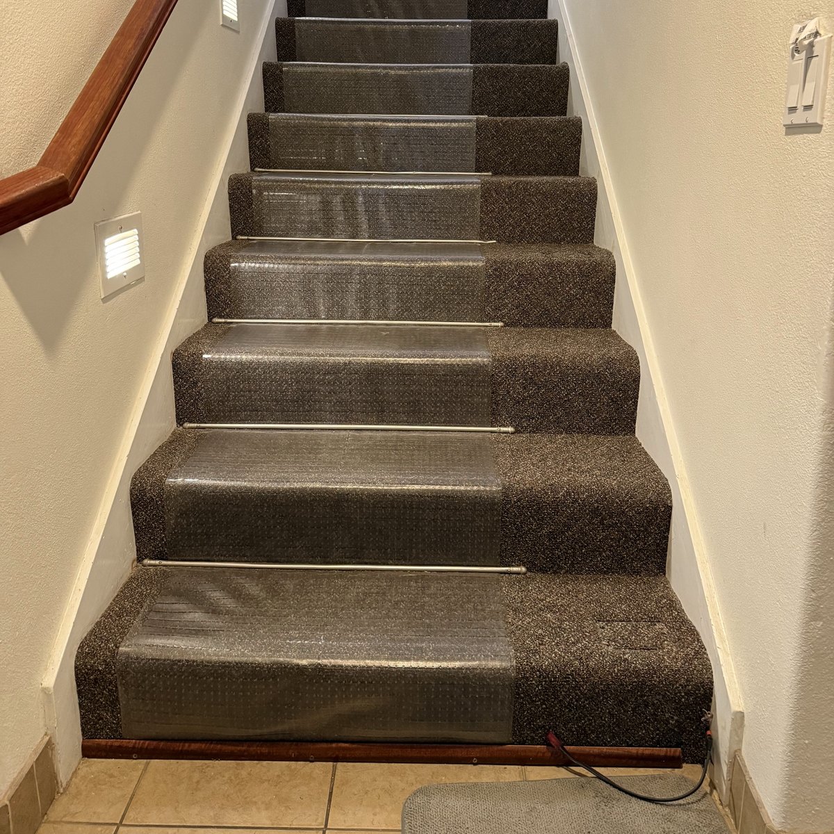The same carpeted staircase before the stair lift was installed